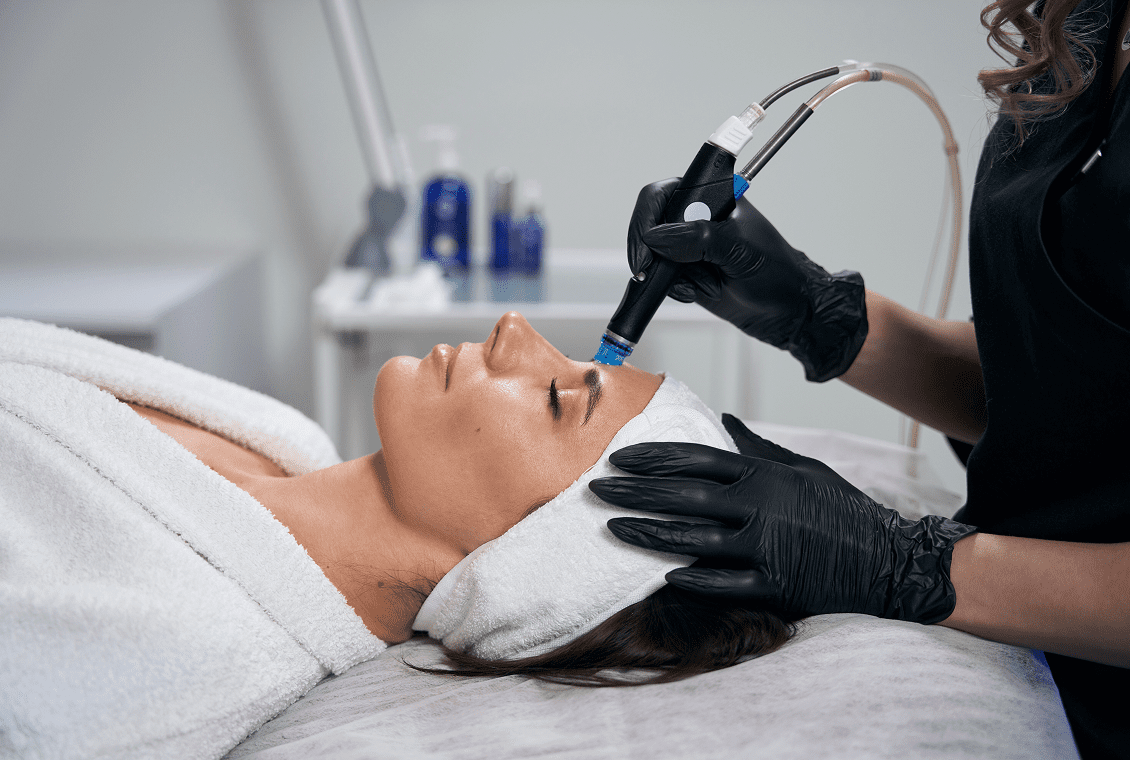 Spa technician performing facial procedure