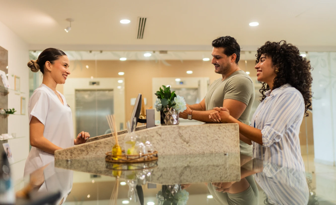Hotel receptionist assisting couple